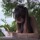 Education Stock Footage 4 K Ultra Hd Clips   A Woman Studying And Writing While Using Her Smartphone - VideoHive Item for Sale