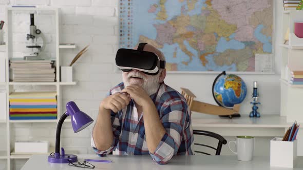 Senior Man Using a Virtual Reality Headset, Senior Old Man Rising His Hand and Trying To Touch
