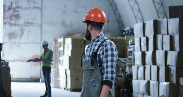 Worker Smiling Into Camera in a Warehouse