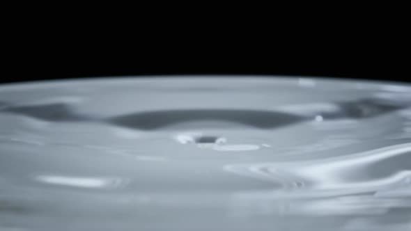 Water Drop Falls on the Water Surface in Slow Motion Macro Shot