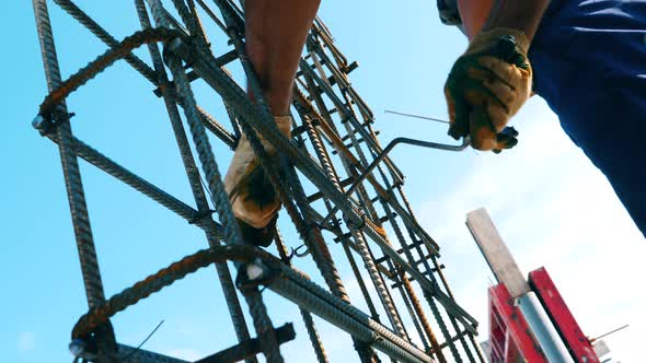 Men Install Metal Construction at a Building Site