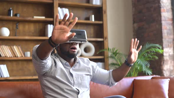 An AfricanAmerican Man Wearing VR Headset at Home