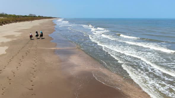 Family Riding Horses on the Seashore