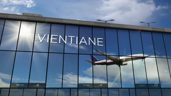 Airplane landing at Vientiane Laos airport mirrored in terminal