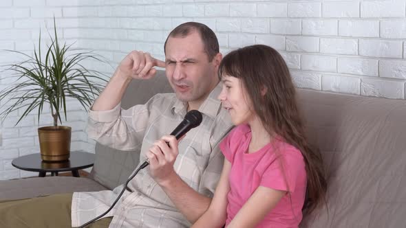 The cheerful family is singing.