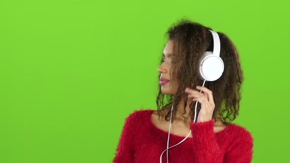 Afro American Girl Dancing with Headphones, Green Screen. Slow Motion