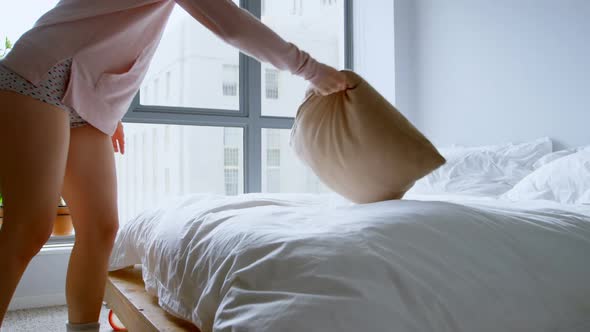 Woman lying on bed in bedroom