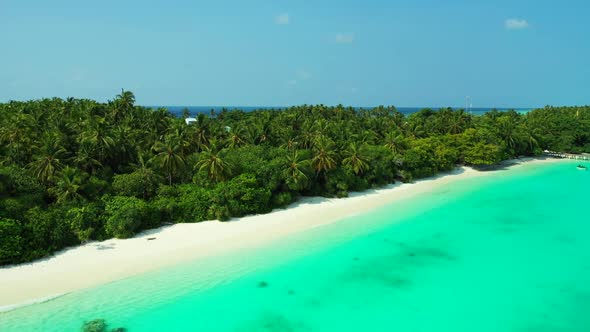 Aerial flying over panorama of paradise tourist beach holiday by transparent ocean with white sand b