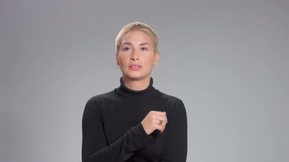 Blonde with Short Haircut in Studio Poses for Camera on Grey Ideal Skin