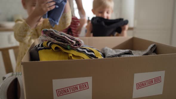 Close up video of children sorting clothes for donation. Shot with RED helium camera in 8K