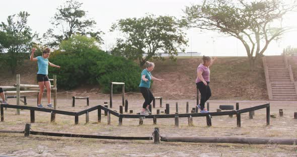 Female friends enjoying exercising at boot camp together