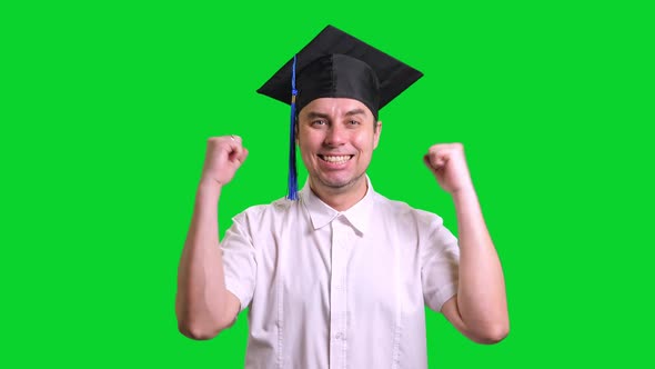 Young Male Graduate in Black Hat on Green Chroma Key Background