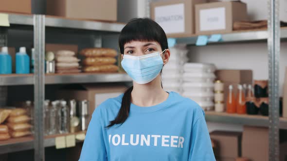 Woman in Face Mask Posing at Charity Donation Center