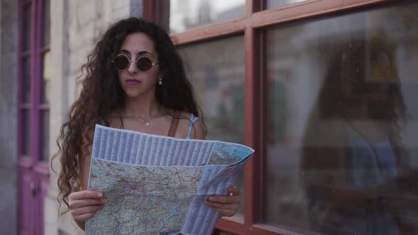 Lost Woman Tourist Reading Map in Old Italian Town