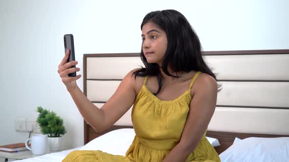 Serious Indian woman talking on a video call