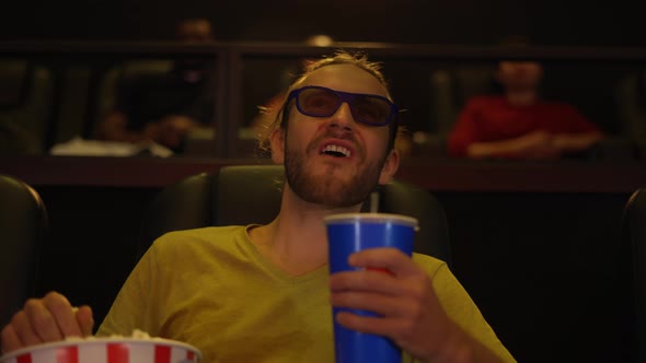 A Man in 3d Glasses Watching Comedy Movie at the Cinema and Eating Popcorn