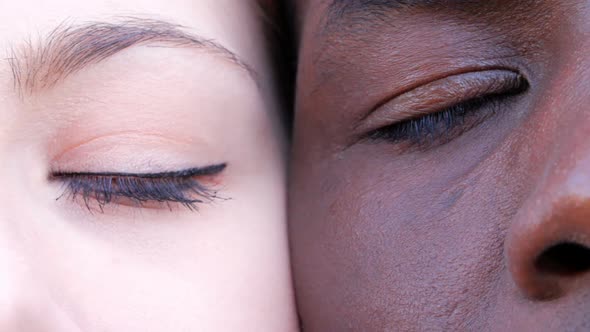 interracial Race Love Concept.Black Man,White Woman's closed Eyes Opening.-Macro