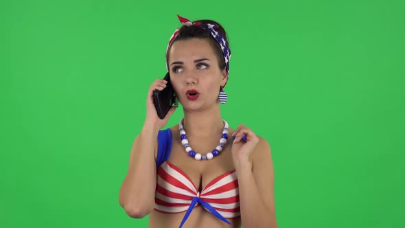Portrait of Beautiful Girl in a Swimsuit Is Talking for Mobile Phone. Green Screen