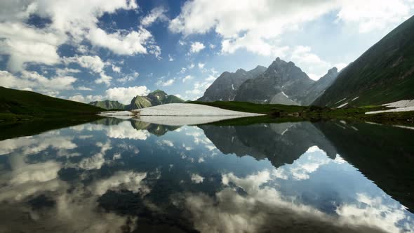 Time lapse clouds reflection in mountain lake Bavarian Alps Germany