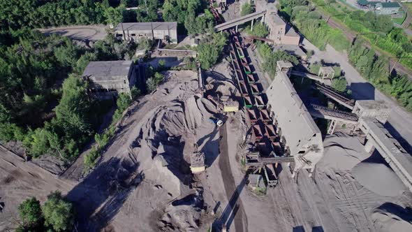 Excavators and Tractors Load Crushed Stone and Rock Into Dump Trucks