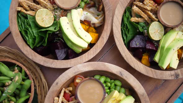 Top View of Raw Vegan Salads Served in Wooden Bowls