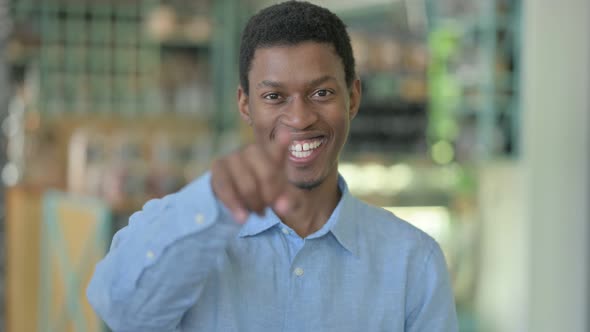 Young African Man Pointing Finger and Inviting 