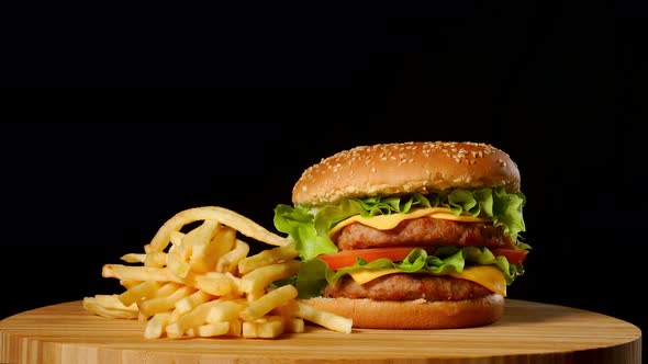 Craft Beef Burger and French Fries, Sauce Isolated on Black Background. Fast Food