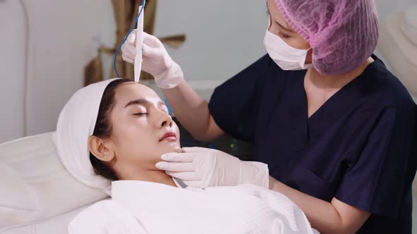 Beauty clinic concept. Young woman getting professional facial procedure.