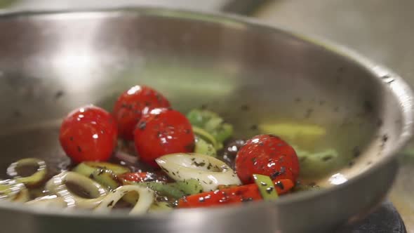 Close Up Shot of an Aluminum Frying Pan, Appetizing Vegetables Are Fried in Oil