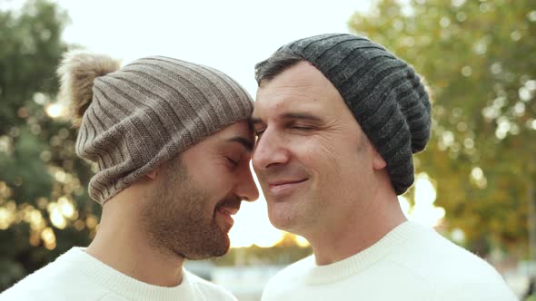 LGBT Gay Men Couple Having Tender Moment Outdoor at City Park in Winter Time