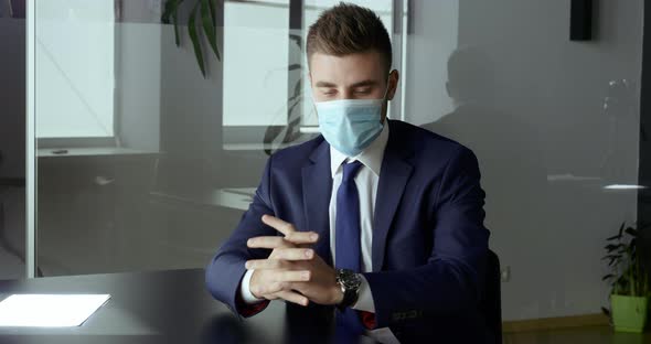 Caucasian Handsome Business Man Puts on Medical Mask on His Face Protects Against Infection