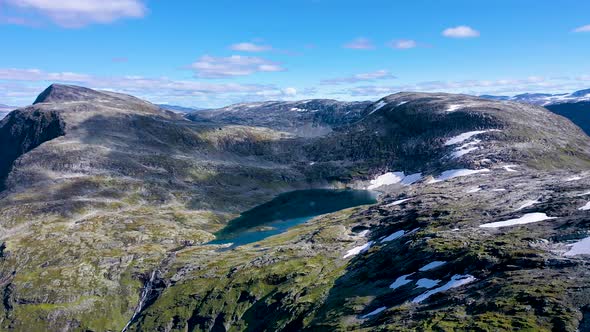 Beautiful hidden lake on top of the mountain range, Alps, Aerial view