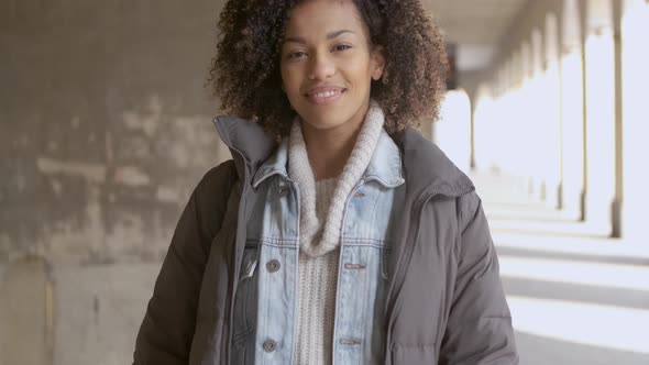 Portrait of Young Mixed Race Woman with Afro Haircut Walking
