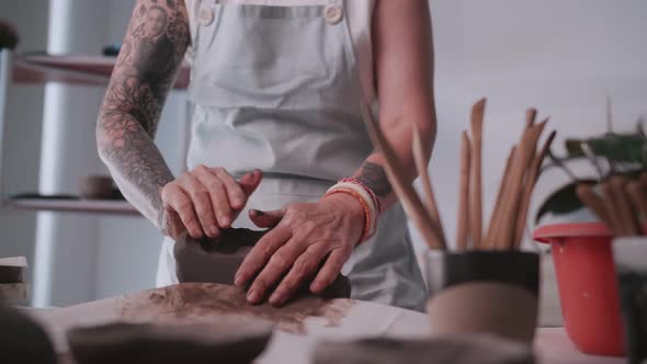 Asian elderly woman enjoying pottery work at home.