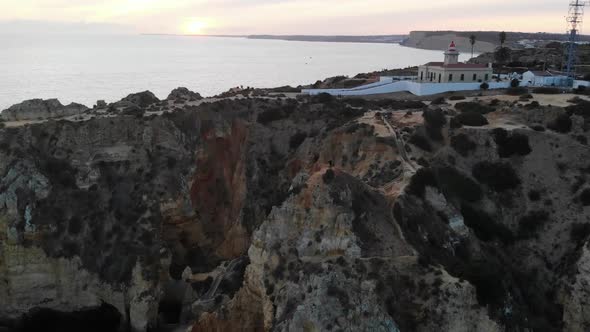 aerial falling away from Farol da Ponta da Piedade Lagos. Lagos, Portugal.  Algarve region is known