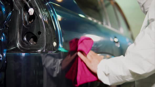 Expert at the Service Station Cleaning a Car Using Rag After Applying Vinyl Film