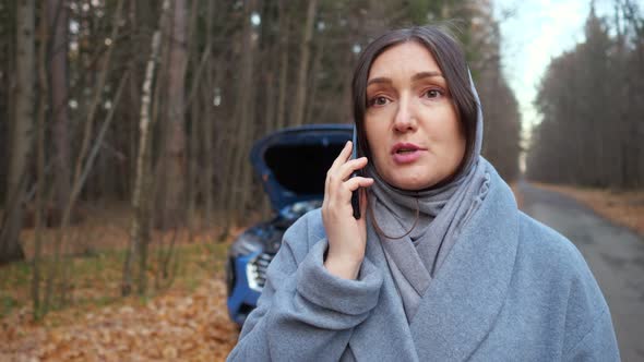 Woman Stands Near Broken Car Calling for Help on Roadside