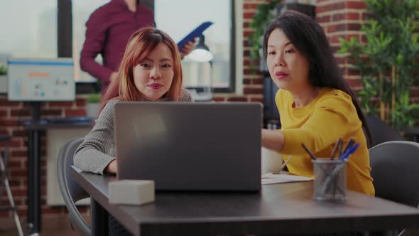 Business Women Pointing at Laptop Screen to Work on Financial Plan