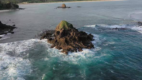 Aerial parallax shot over the Bukit Merese, Merese Hills in Lombok. Rough sea waves splashing on the