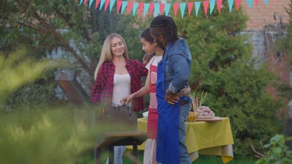 Smiling Happy Caucasian Mother Wife Walking to African American Husband Father and Teenage Daughter