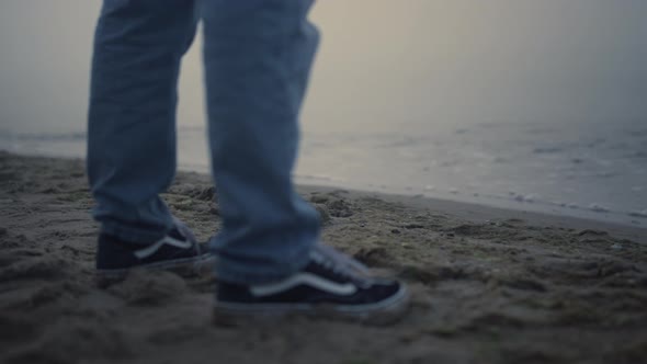 Guy Legs Sneakers Standing on Sea Beach