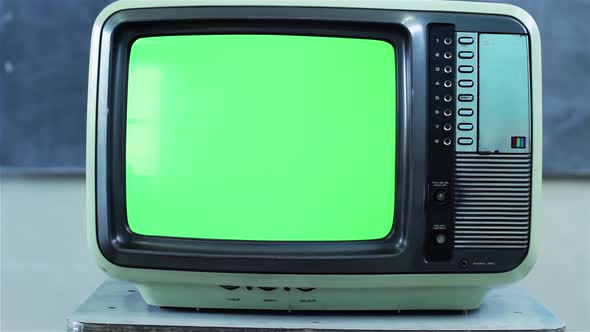 Retro TV Set turning on Green Screen with Color Bars in Classroom. Dolly In. 4K Version.