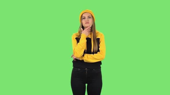 Modern Girl in Yellow Hat Is Thinking About Something, and Then an Idea Coming To Her. Green Screen