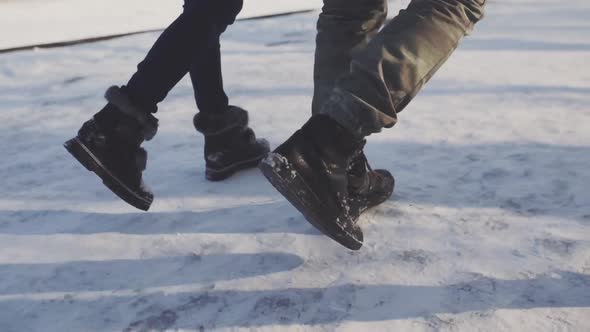 Feet Walking in the Snow with Tracking Shoes