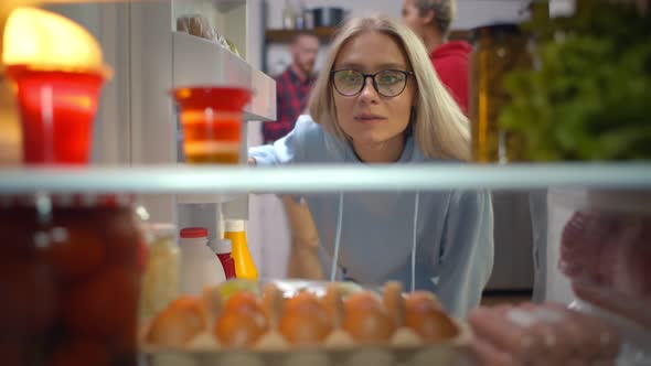 Young Hipster Woman Looking Inside Fridge Searching for Snack
