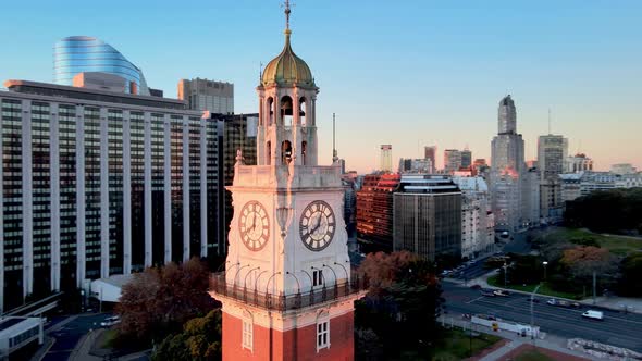 Torre Monumental glowing in vivid morning sunrise, Buenos Aires; aerial orbit