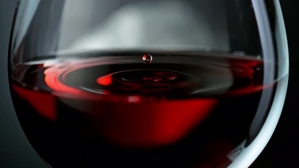 Super Slow Motion Shot of Wine Drop Falling Into Red Wine in Glass at 1000Fps