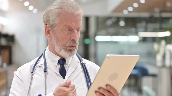 Senior Old Doctor Doing Video Chat on Tablet