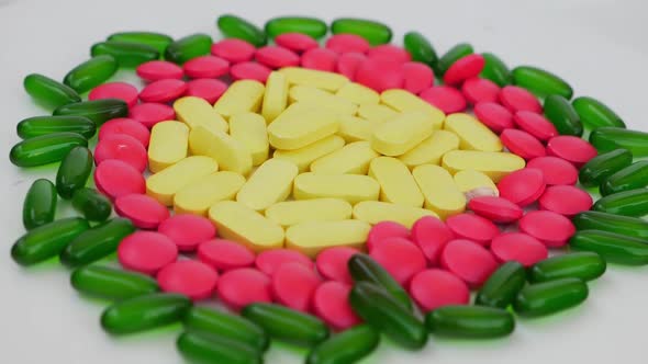 Rotating shot of colorful tablets placed over a white background