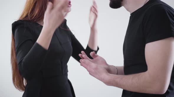 Unrecognizable Caucasian Man and Woman Gesturing Emotionally and Yelling. Young Married Couple